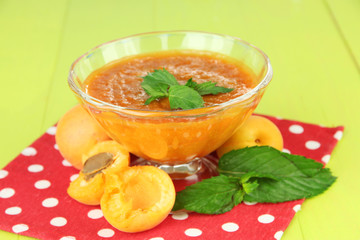 Apricot jam in glass bowl and fresh apricots,