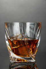 Glass of whiskey, on dark background