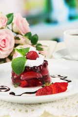 Tasty jelly dessert with fresh berries, on bright background