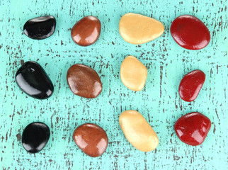 Colorful pebbles, on color wooden background