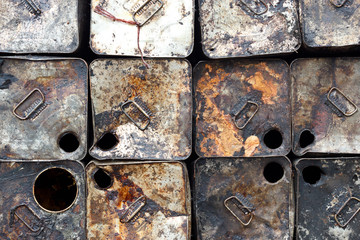 old oil tin packing is stacked outdoors