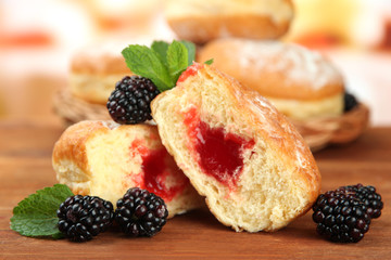 Tasty donuts with berries on wooden table