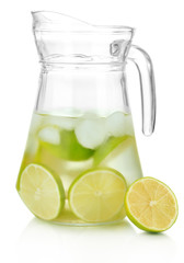 Cold water with lime, lemon and ice in pitcher isolated on