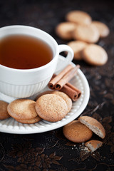 Homemade cookies with cinnamon and a cup of tea, selective focus