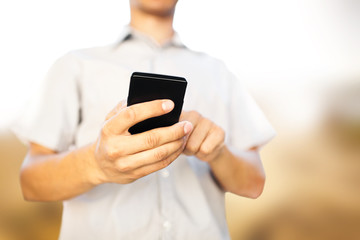 Close up of a man using mobile smart phone