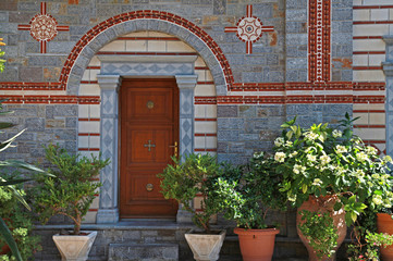Fototapeta na wymiar door entrance and flower pots in beautiful greek monastery(Greec