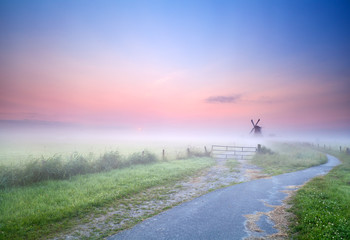 way to windmill in morning fog