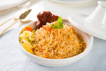 Biryani rice or briyani rice, curry chicken and salad, tradition