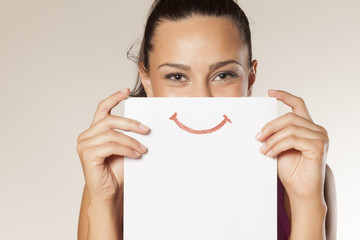 happy and smiling girl with a smile painted on paper - Powered by Adobe