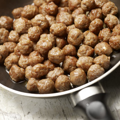tasty meatballs beeing prepared in a frying pan