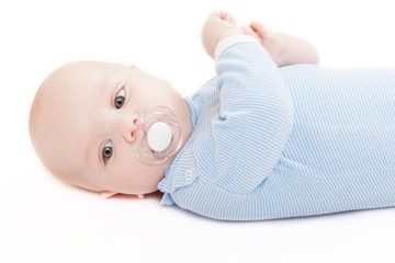 baby in striped body stockings lies on a white background