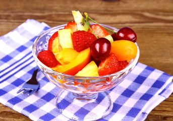 Fruit salad in glass bowl with dessert fork