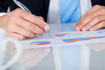 Businessman Writing On Graph