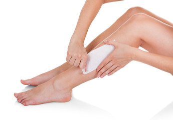 Close-up Of Woman Waxing Legs