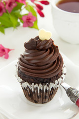 Chocolate muffins with chocolate cream.