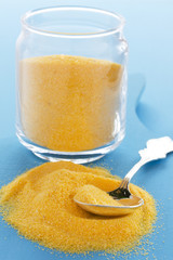 Corn flour, polenta on a blue background.