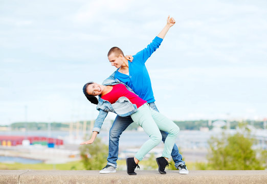 Couple Of Teenagers Dancing Outside