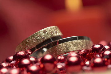 Wedding rings and red pearls