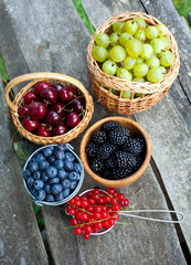different berries on wooden table