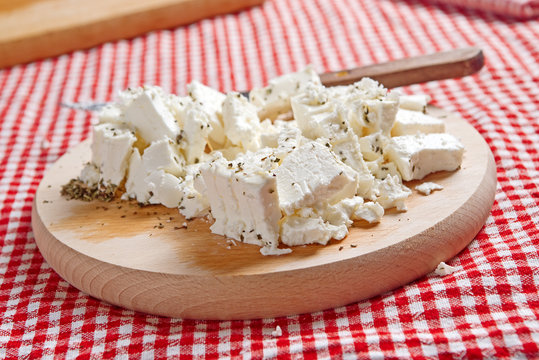 Feta cheese on wooden plate
