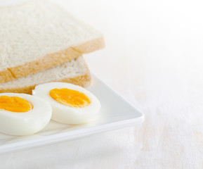 Boiled egg and toasts on white plate