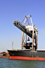 Fototapeta na wymiar unloading of an ore cargo liner