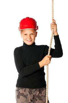 boy builder in helmet holding a rope