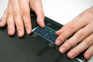 Man installing memory. Laptop RAM upgrade