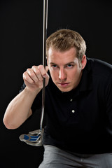 Young man holding a golf club