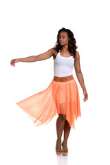 playful black woman with orange skirt