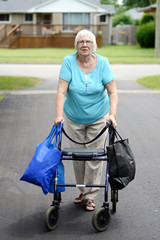 senior woman and walker overloaded with shopping bags