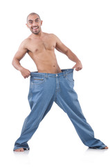 Fototapeta premium Man in dieting concept with oversized jeans