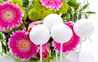 white cake pops with purple flower