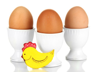 Whole boiled eggs in eggs cups isolated on white