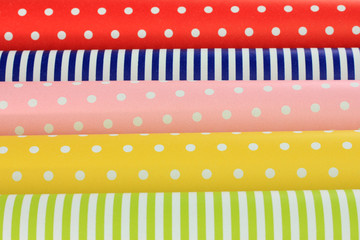 Color papers for wrapping gifts close-up background