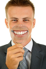 Businessman with magnifying glass zooming on his smile