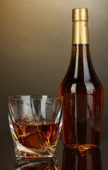 Glass of whiskey with bottle, on dark background