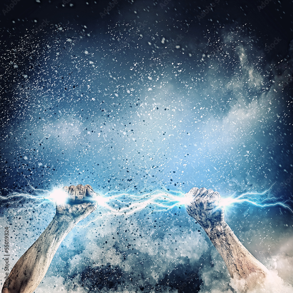 Wall mural human hand holding lightning