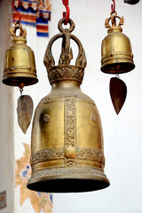 Brass bell hanging in front of the Buddhism church.