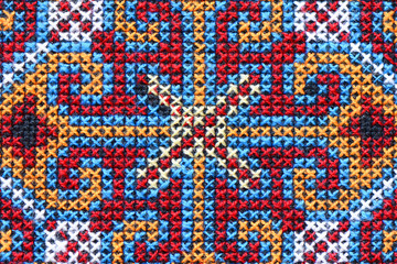 Cross stitch embroidery on canvas.