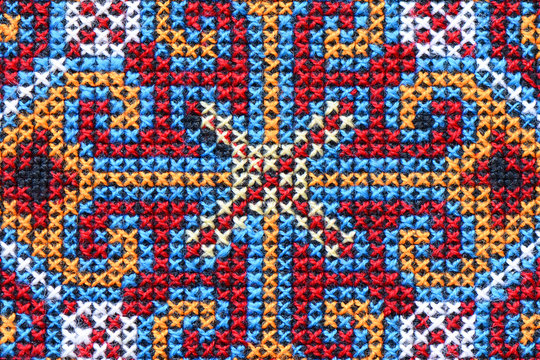 Cross stitch embroidery on canvas.