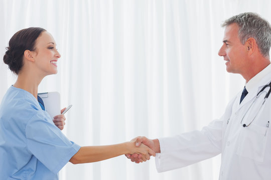 Surgeon and doctor shaking hands