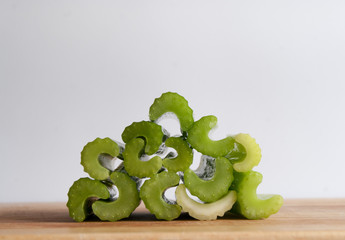 Pile of celery stalks on chopping board