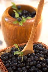 mortar with fresh forest blueberries