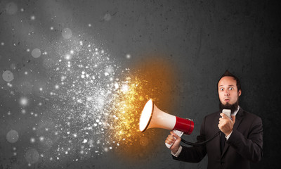 Guy shouting into megaphone and glowing energy particles explode