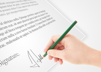 Hand writing personal signature on a paper form