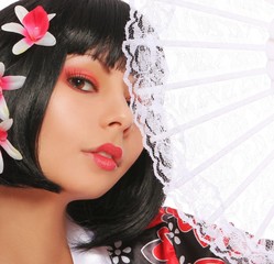 geisha with lace fan and beautiful flowers in her black hair