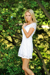 Portrait of a beautiful young lady in summer park