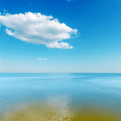 Fototapeta na wymiar yellow color shallow waters of the sea and cloud over it