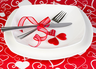 A romantic table setting with hearts and ribbon close up